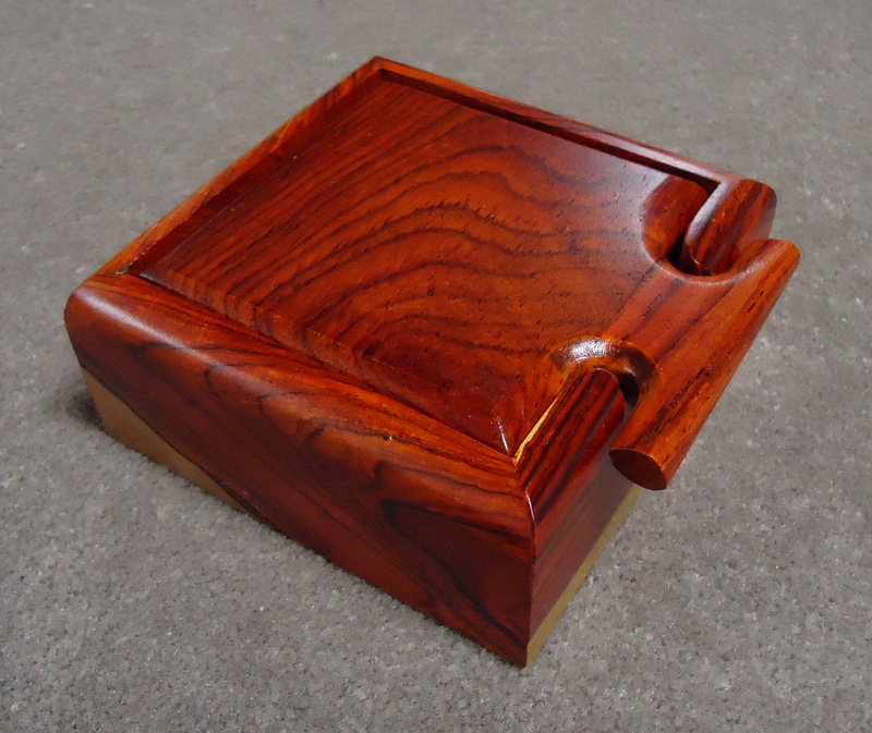 Small square box with
                    T-shaped handle